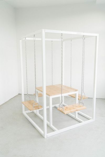 a white table with a chair and a white table