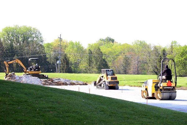 a few tractors working in a field