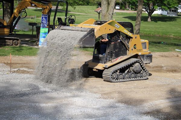 a yellow tractor in a muddy area